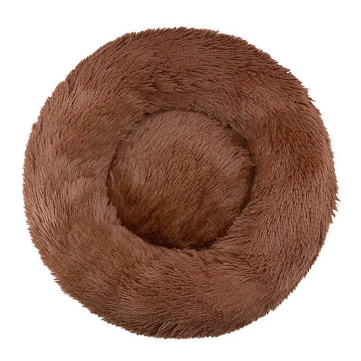 Varm och mysig rund kattbädd av plyschmaterial, perfekt sovplats för kalla dagar.