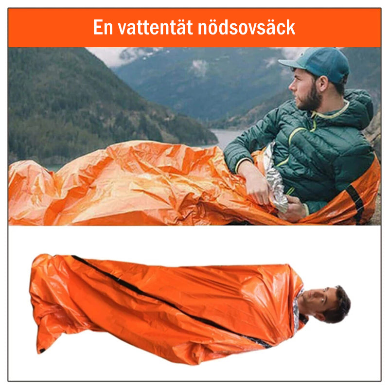 "Nödsovsäck utomhus, vattentät och kompakt i orange, för camping och äventyr, synlig vid nödsituationer."