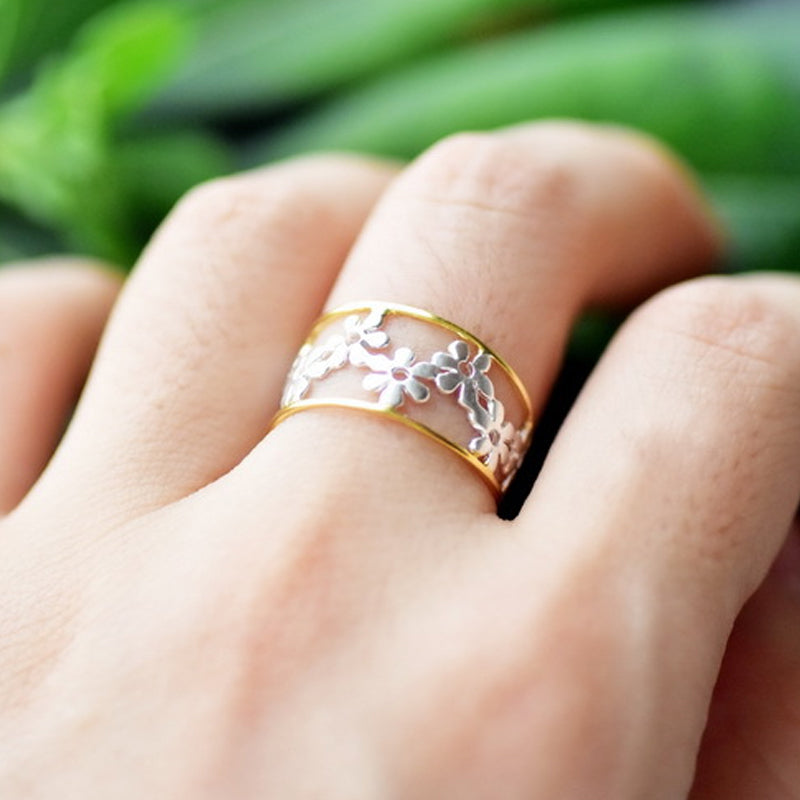 Oregelbunden ihålig tusensköna ring för kvinnor, justerbar design i legering, elegant och handgjord accessoar.