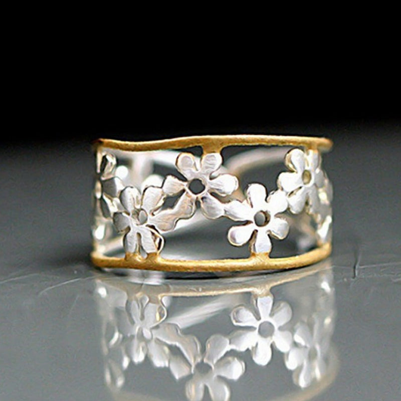 Oregelbunden ihålig tusensköna ring för kvinnor, justerbar design i legering, elegant och handgjord accessoar.