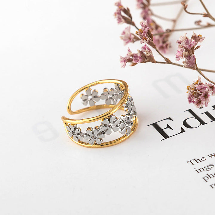 Oregelbunden ihålig tusensköna ring för kvinnor, justerbar design i legering, elegant och handgjord accessoar.