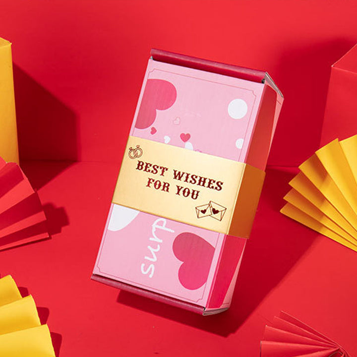 "Överraskningshoppande presentask i livfulla färger, perfekt gåva med popup-effekter, innehåller rosa och gula nyanser."