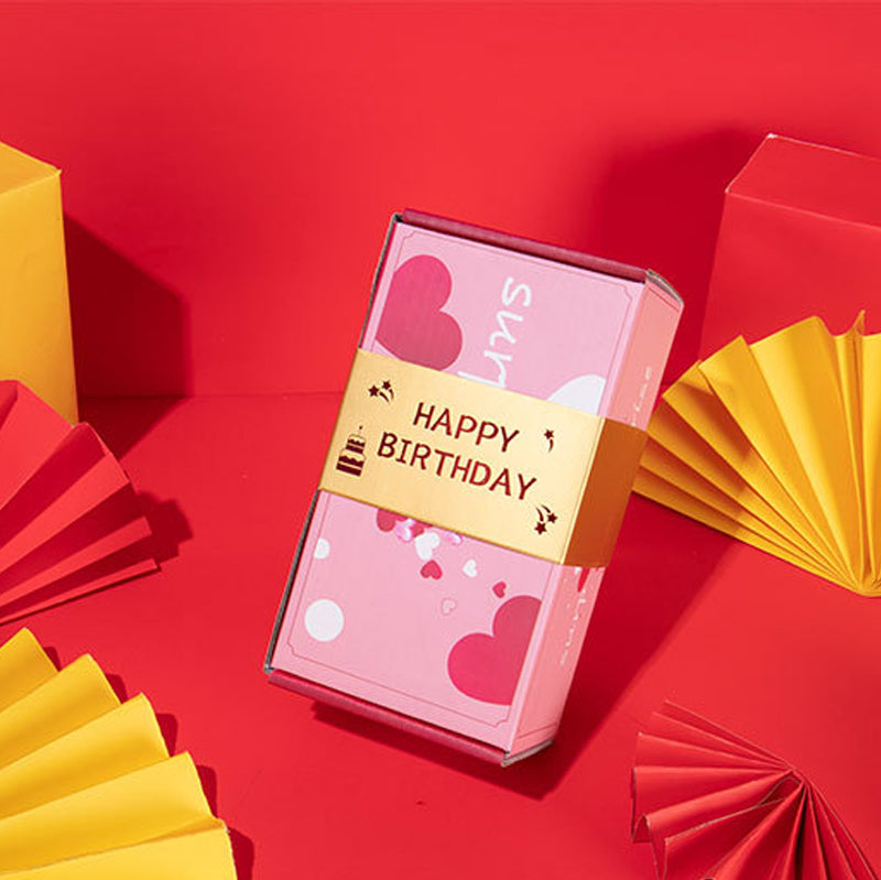 "Överraskningshoppande presentask i livfulla färger, perfekt gåva med popup-effekter, innehåller rosa och gula nyanser."