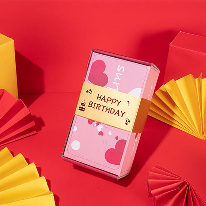 "Överraskningshoppande presentask i livfulla färger, perfekt gåva med popup-effekter, innehåller rosa och gula nyanser."