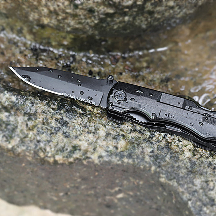 Portabel multifunktionell fällkniv av hållbart stål, kompakt design, ergonomiskt grepp, verktyg för utomhusäventyr.