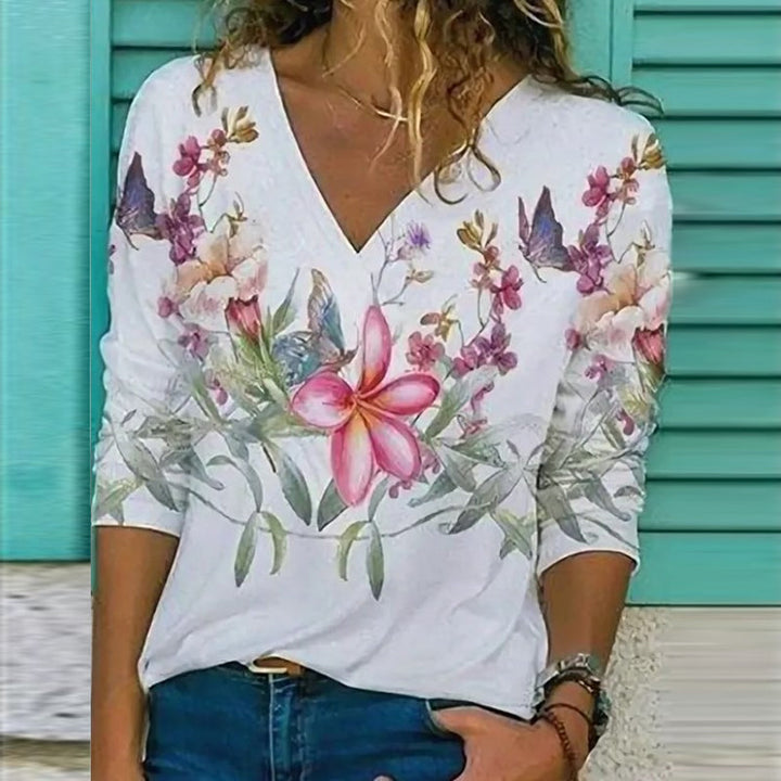 "Retro v-ringad blommig långärmad t-shirt för damer, elegant mönster och stilfull design i flera färgrika nyanser."