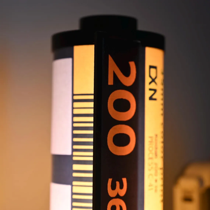 Detaljbild av RetroGlow retro lampa. Svart filmkassett design, elegant belysning. En stilfull inredningspresent.