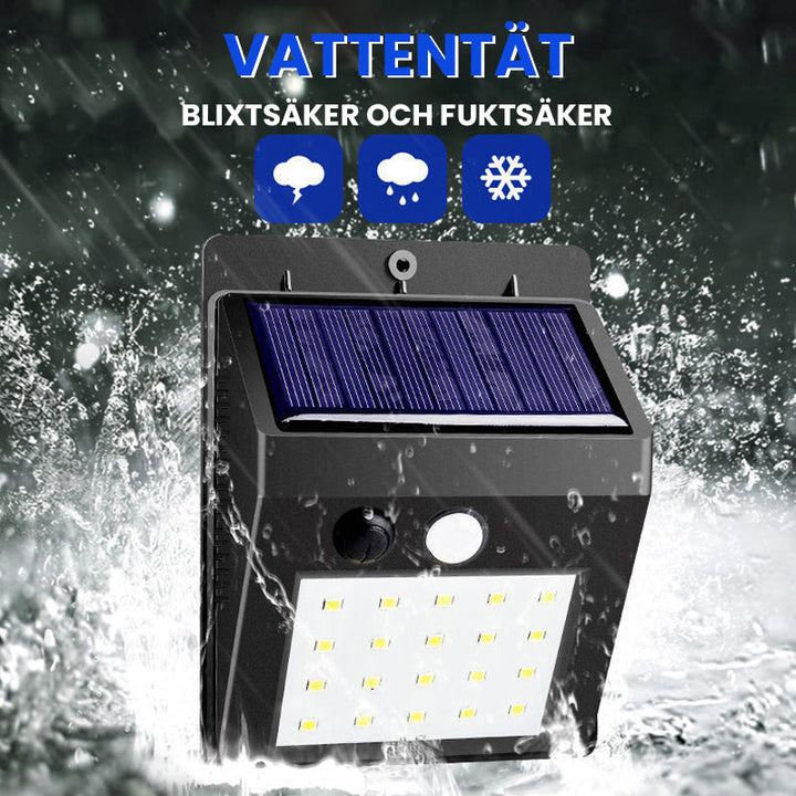 "Rörelsesensor LED-lampa utomhus IP65, solcellsdriven med 30 LED, robust svart design, perfekt för trädgårdsbelysning."