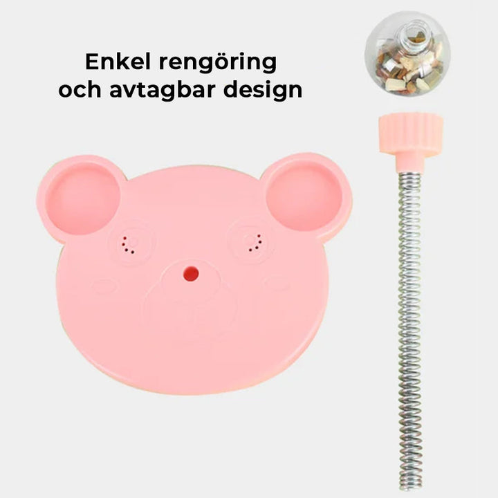 "Rosa och blå interaktiv automatisk bollmatare för husdjur, med bollar och sugkoppar för stabilitet och lekglädje."
