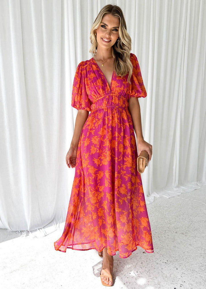 Elegant damklänning: blommig midiklänning med puffärmar i rosaorange. Perfekt som vardags- eller festklänning.