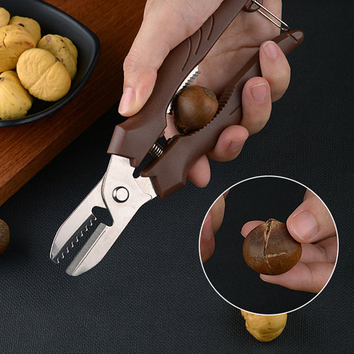 "Rostfri nötöppnare med brun detaljer, ergonomisk design för enkel öppning av valnötter och kastanjer i köket."