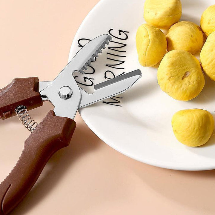 "Rostfri nötöppnare med brun detaljer, ergonomisk design för enkel öppning av valnötter och kastanjer i köket."