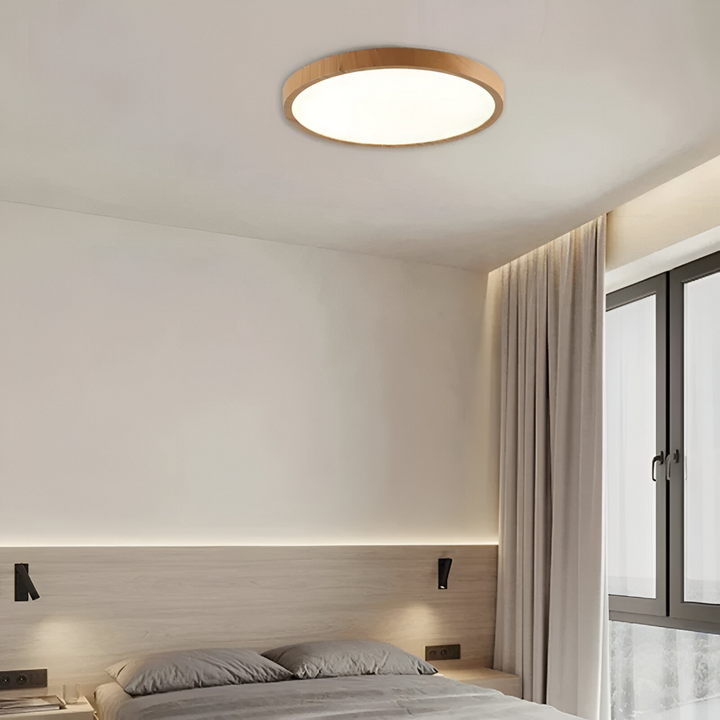 Energieffektiv rund LED taklampa med justerbar ljusfärg, idealisk som sovrumslampa.
