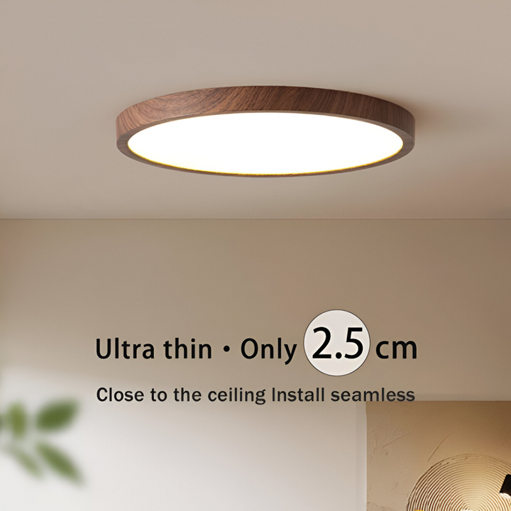 Elegant rund LED taklampa valnötsfinish & justerbar ljusfärg, skapar stämningsfull belysning.