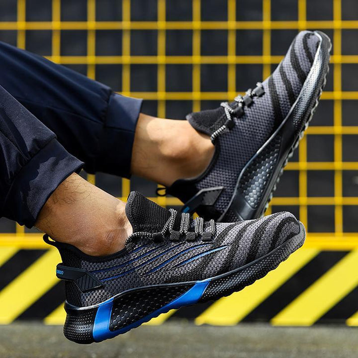 "Säkerhetsskor för män med ståltåhätta, mörk färg, halksäker sula, idealisk för arbetsmiljö, robust design."