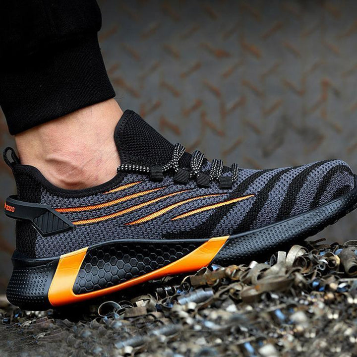 "Säkerhetsskor för män med ståltåhätta, mörk färg, halksäker sula, idealisk för arbetsmiljö, robust design."