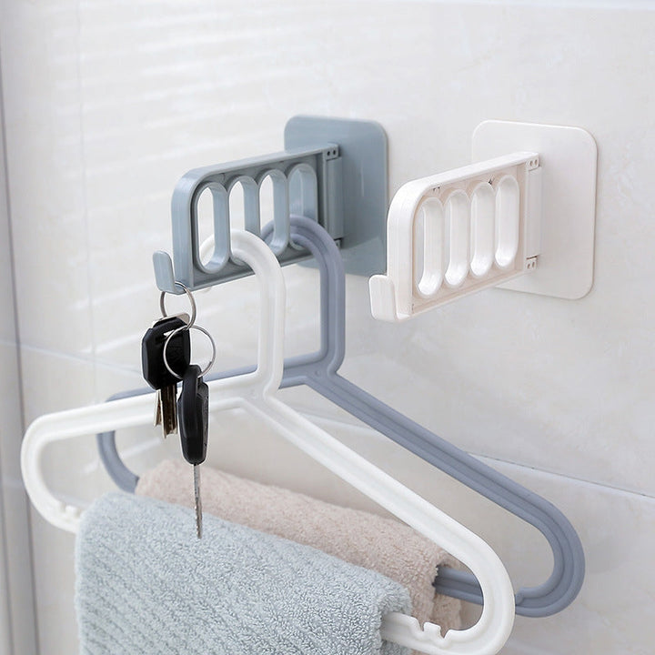 Självhäftande hopfällbar hängare i grå och vit PVC, rotationsdesign, 4 hål och krok, för hemförvaring utan borrning.