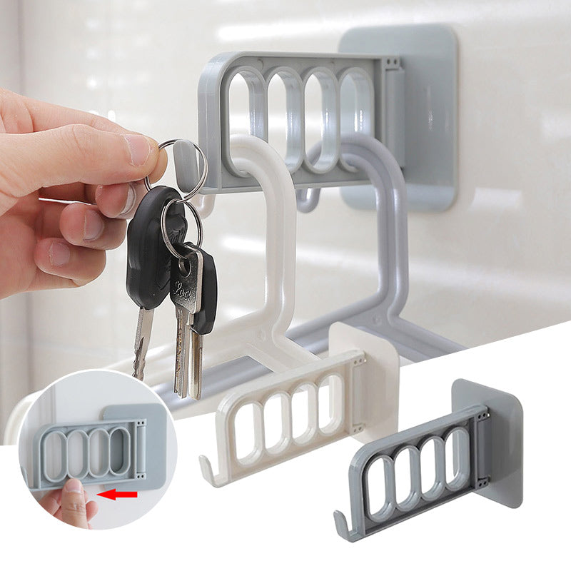 Självhäftande hopfällbar hängare i grå och vit PVC, rotationsdesign, 4 hål och krok, för hemförvaring utan borrning.