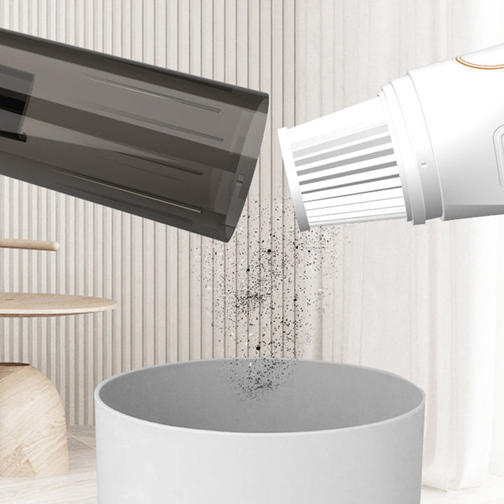 Sladdlös handdammsugare, vit/svart, för hem och bil, lätt och ergonomisk design för snabb städning av svåråtkomliga områden.