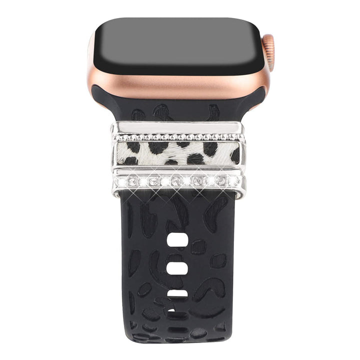 "Smartklockband med dekorativa metallringar i gyllene leopardmönster och roséguldstjärnor, elegant stilaccessoar."
