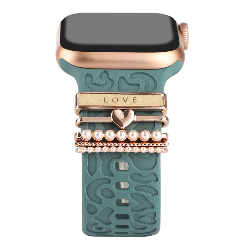 "Smartklockband med dekorativa metallringar i gyllene leopardmönster och roséguldstjärnor, elegant stilaccessoar."