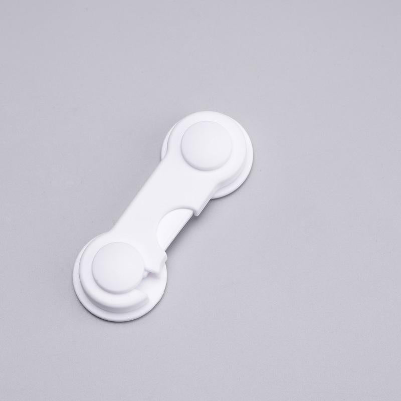Smidigt säkerhetslås i vit plast för barn, enkelt att installera på dörrar och skåp för att förhindra olyckor.