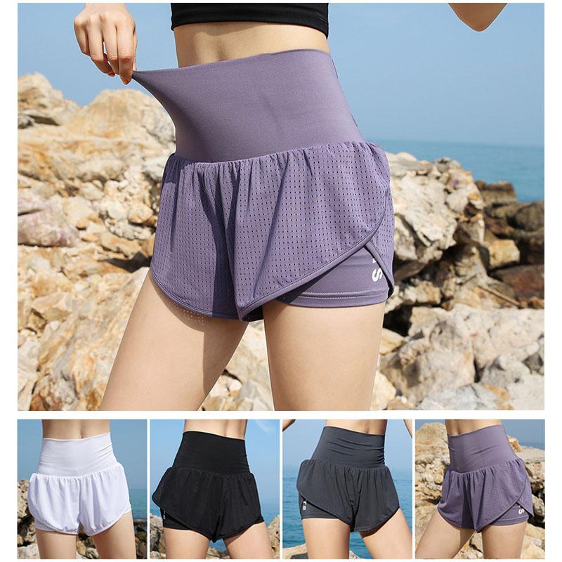 "Snabbtorkande damshorts med hög midja och fickdesign, elastiskt tyg i polyester och spandex för aktivt sportande."