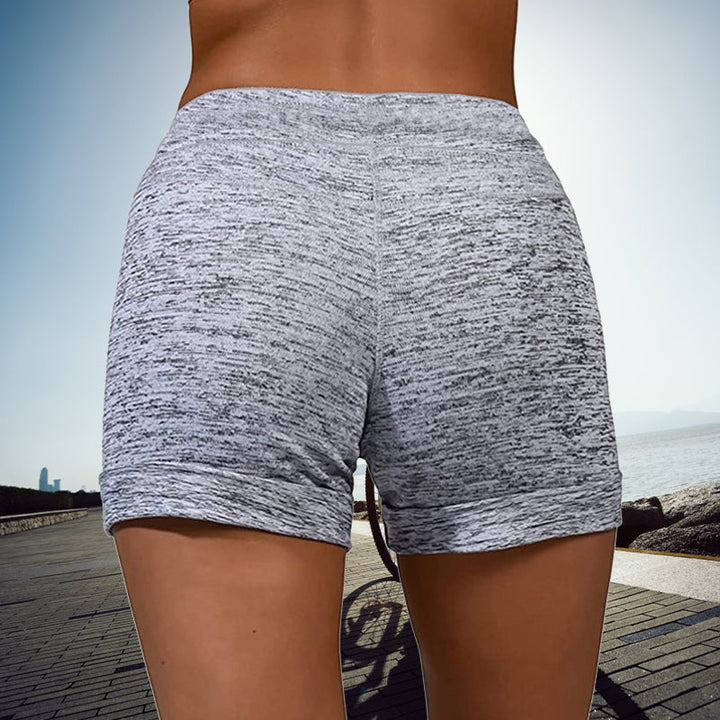 "Snabbtorkande damshorts med mini-längd, elastisk midja och två fickor, perfekt för sommarmode och aktiviteter."