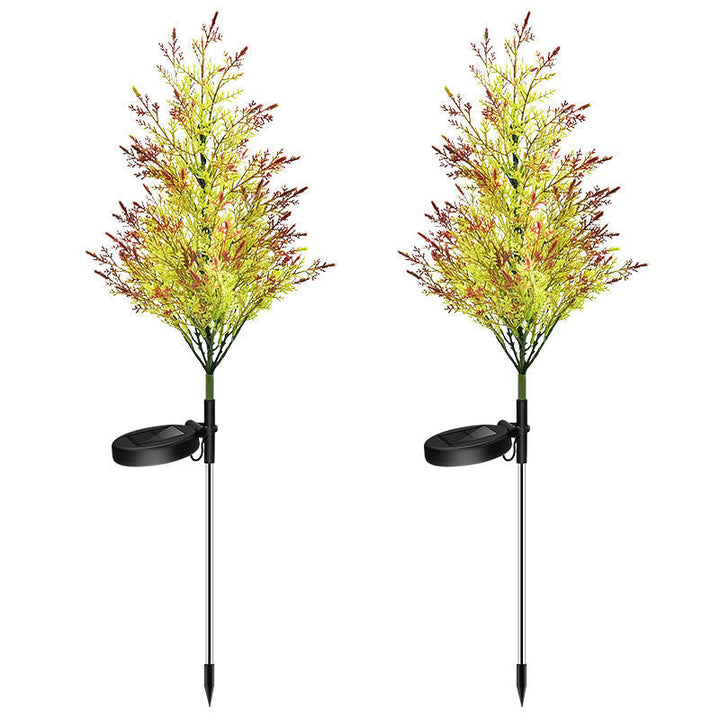 "Solcellsdriven RGB trädgårdsbelysning för jul, naturinspirerad design med cypress- och tallbladseffekt, magisk atmosfär."