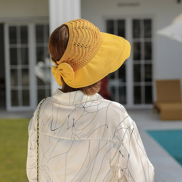 "Sommarmodesolhatt med bredt brätte, gul, UV-skydd, damaccessoarer, elegant, skyddar ansikte mot solen, bärbar design."