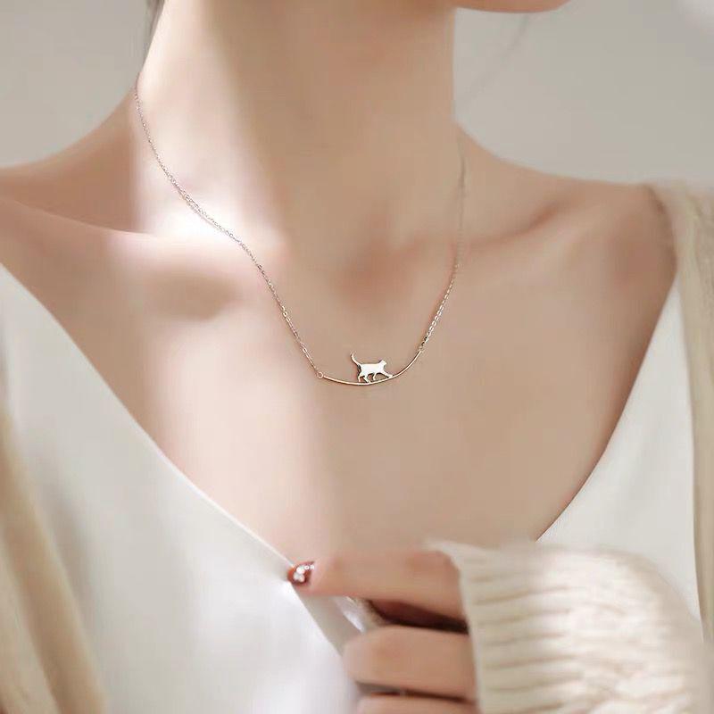 "Sött halsband med gående katt i guld och silver, perfekt för alla åldrar. Kvinnors accessoar som utstrålar charm och elegans