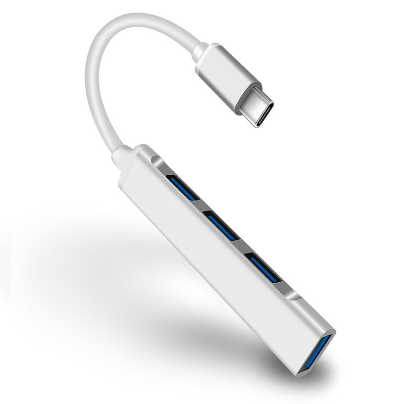 "Stilren USB Typ C HUB i silver med 4 portar för snabb anslutning och höghastighetsöverföring, kompakt och användarvänlig."