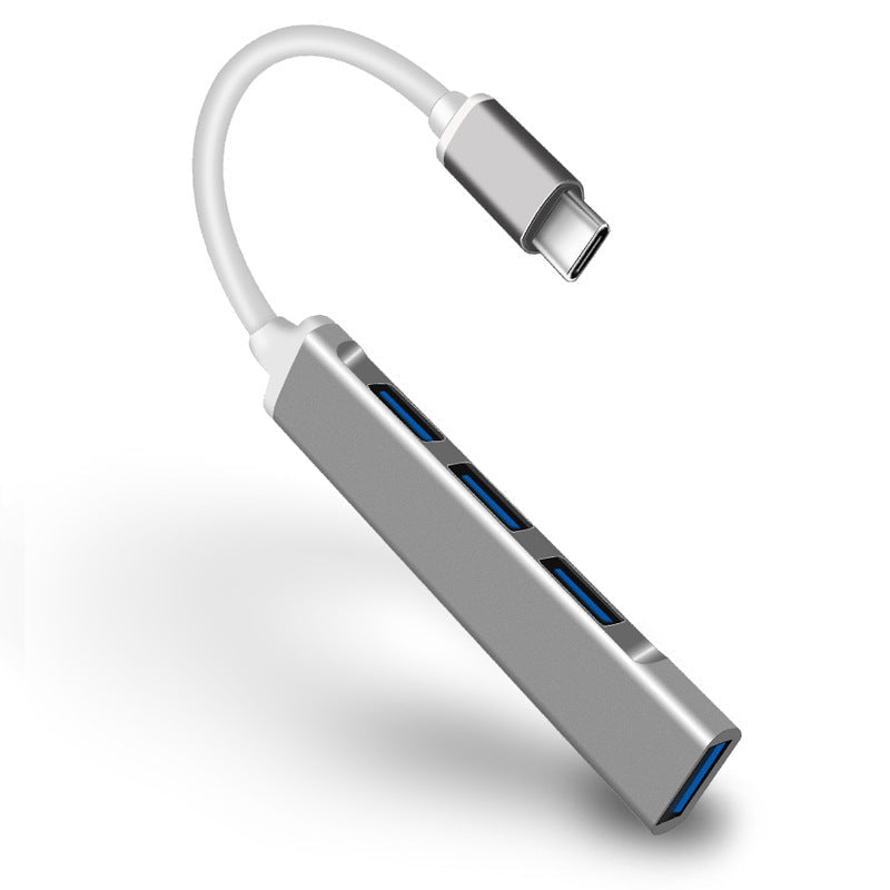 "Stilren USB Typ C HUB i silver med 4 portar för snabb anslutning och höghastighetsöverföring, kompakt och användarvänlig."