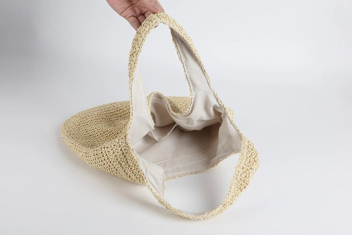 Kvinnors solkyssta axelväska, brun beige ton. En modern och rymlig tote för sommarlovet.