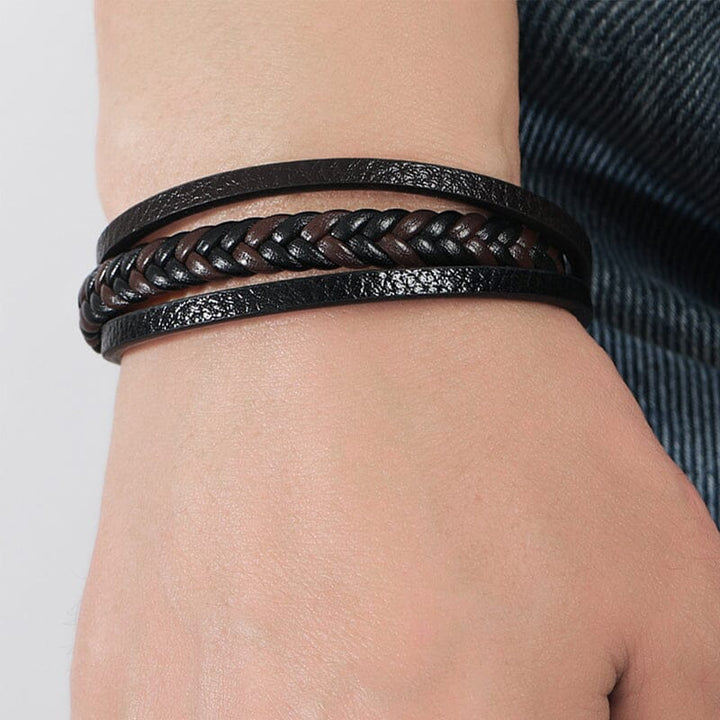 "Svart flätat läderarmband med hematitpärlor, stresslindrande och elegant accessoar för moderna män."