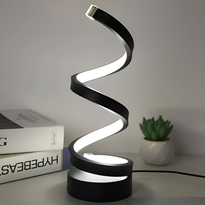 Dekorativ LED-bordslampa i svart spiraldesign, dimbar med 3 ljusfärger, passar i vardagsrum eller sovrum.