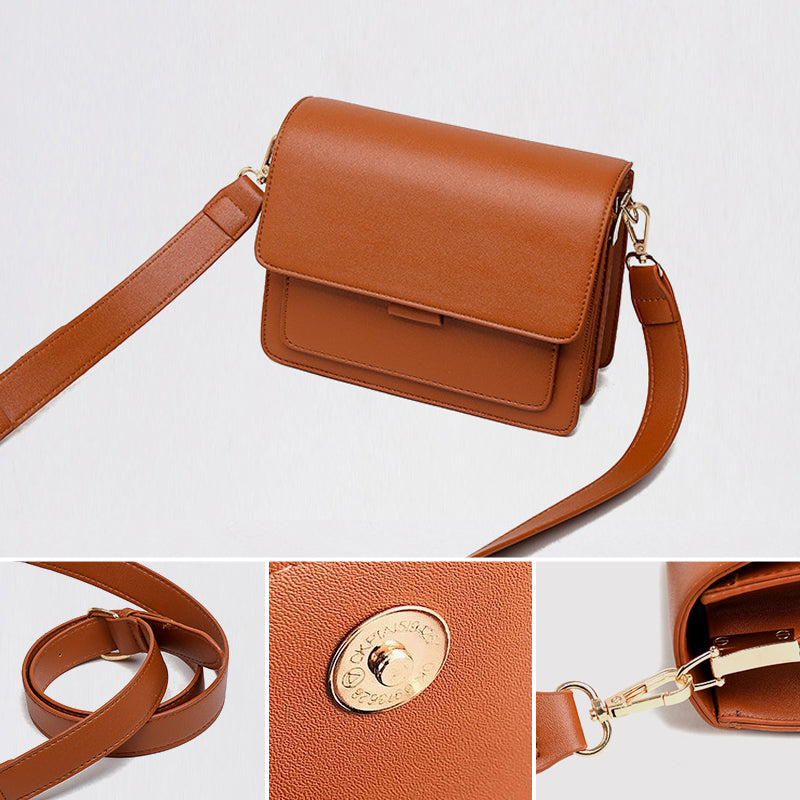 Svart retro crossbody väska i konstläder med minimalistisk design och flera fack för damaccessoarer.