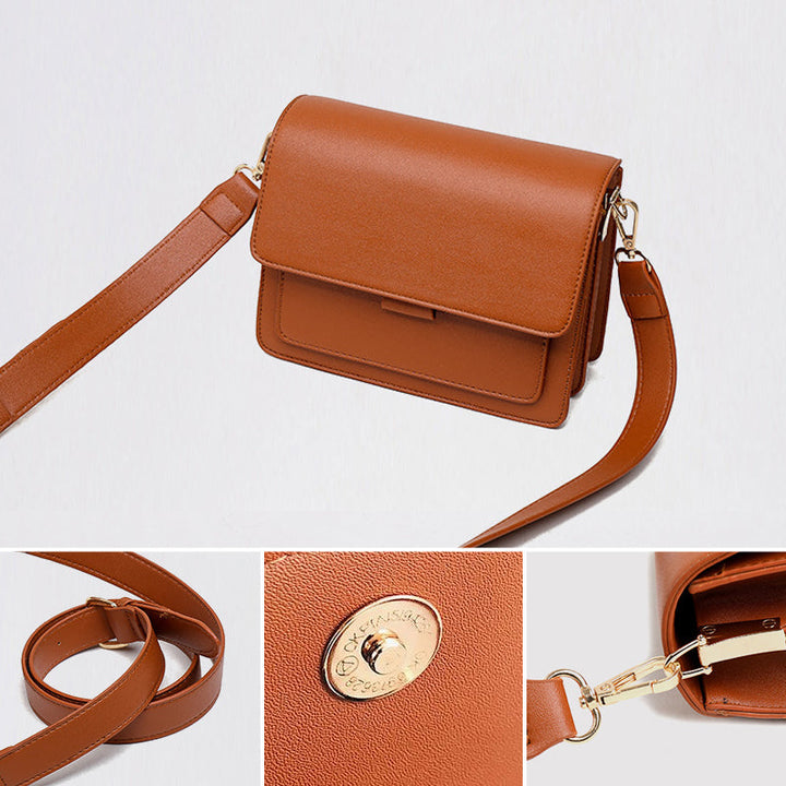 Svart retro crossbody väska i konstläder med minimalistisk design och flera fack för damaccessoarer.