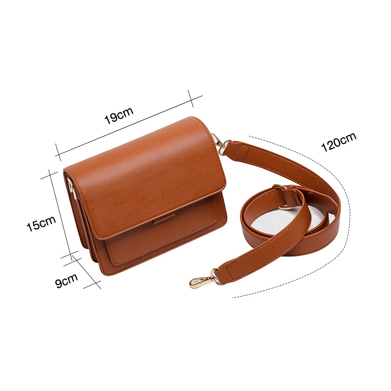Svart retro crossbody väska i konstläder med minimalistisk design och flera fack för damaccessoarer.