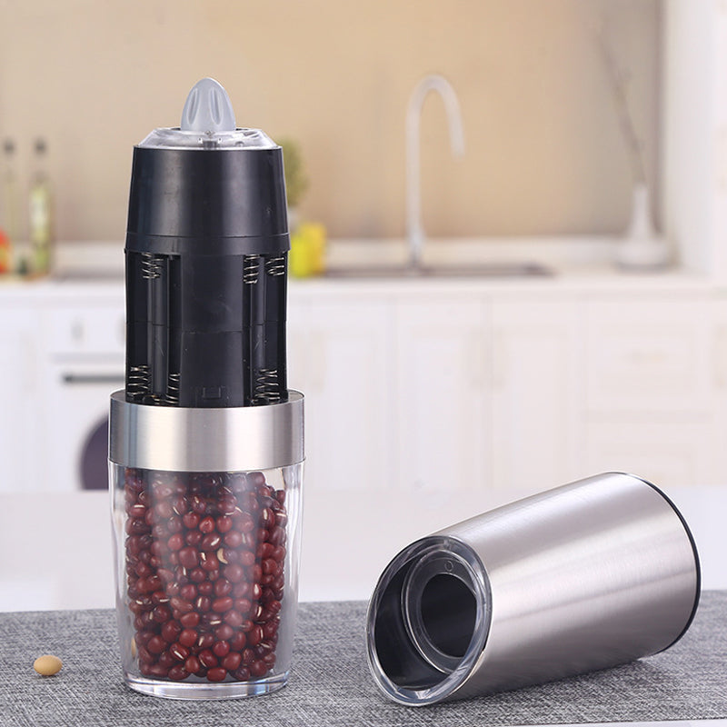 "Svart-silver elektrisk salt- och pepparkvarn med gravitationsinduktion, hållbar design i rostfritt stål och glas."