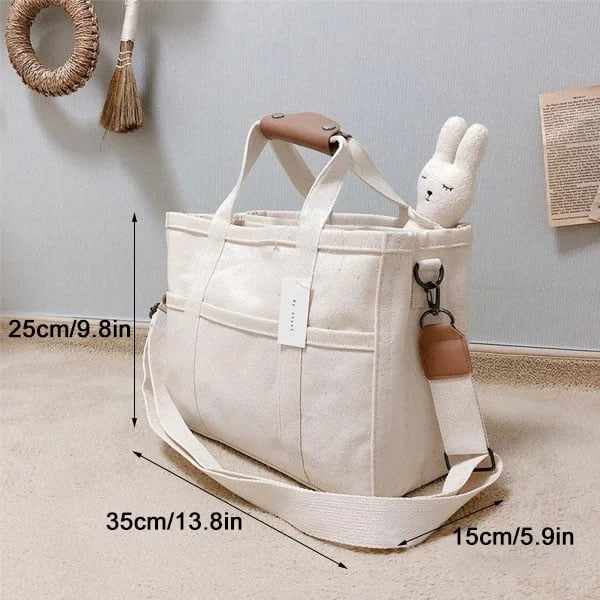 Mångsidig unisex bärkasse i beige, fungerar som axelväska eller shoppingväska. Elegant för en organiserad vardag.