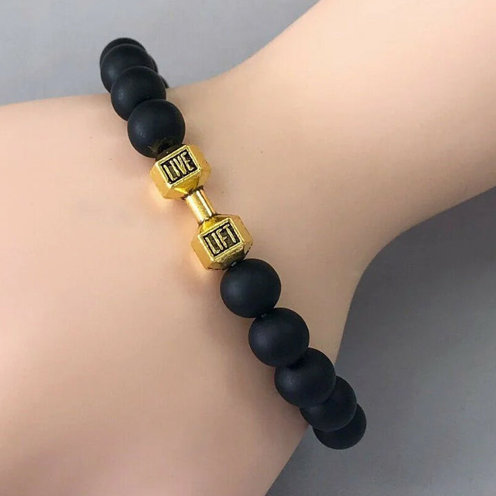 "Svart unisex hantelarmband i onyx och lavasten för chakra, elegant design, naturliga stenar, accessoar för energi och stil."