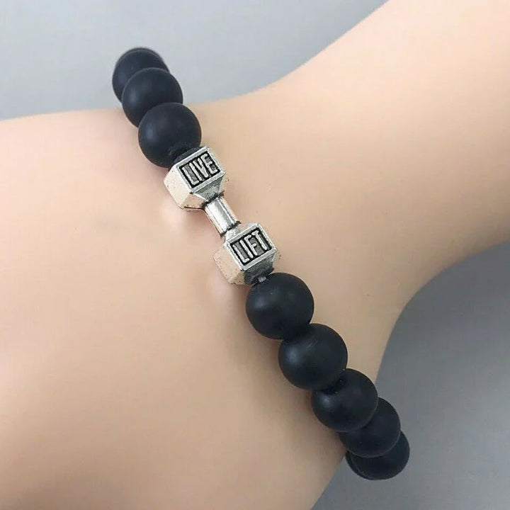 "Svart unisex hantelarmband i onyx och lavasten för chakra, elegant design, naturliga stenar, accessoar för energi och stil."