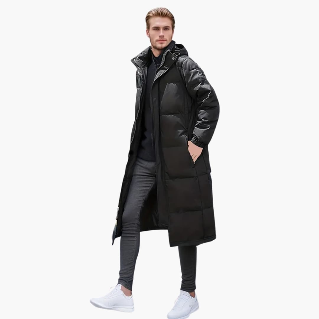 Herrjacka i svart, vadderad och lång modell med avtagbar huva, perfekt ytterplagg för streetwear.