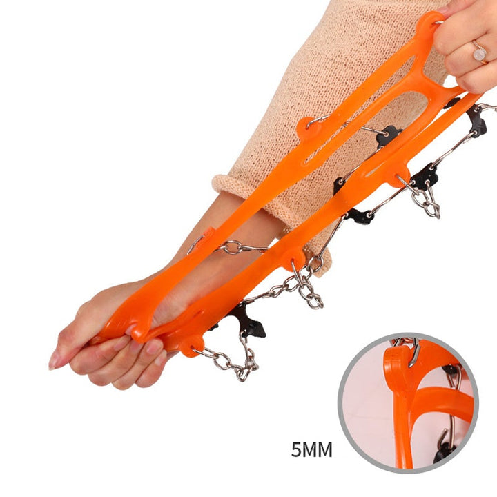 "Svart/orange unisex vintergrepp för skor med 8 isspikar av rostfritt stål och elastisk silikon, ger säkert grepp på is."