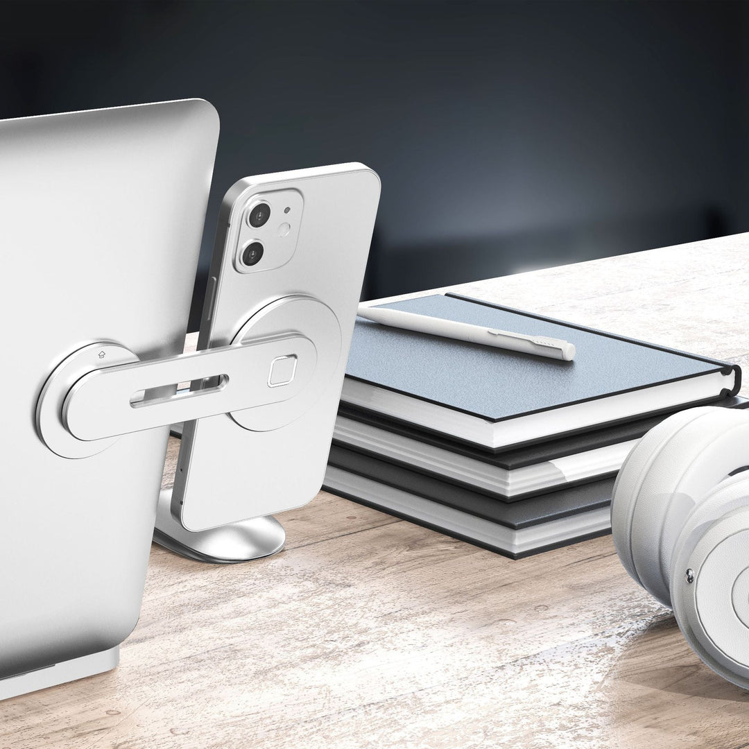 "Svart/silver magnetisk telefonhållare i aluminium monterad på datorskärm, passar smartphones och iPad mini."