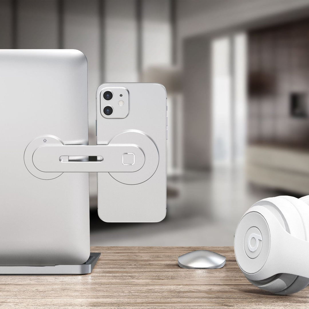 "Svart/silver magnetisk telefonhållare i aluminium monterad på datorskärm, passar smartphones och iPad mini."