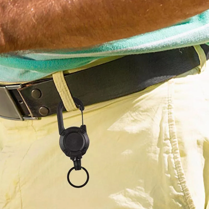 "Svart/vit multifunktionell nyckelring med infällbar vajer, hållbar aluminiumkarbin för utomhusbruk, ca 12,5 cm lång."