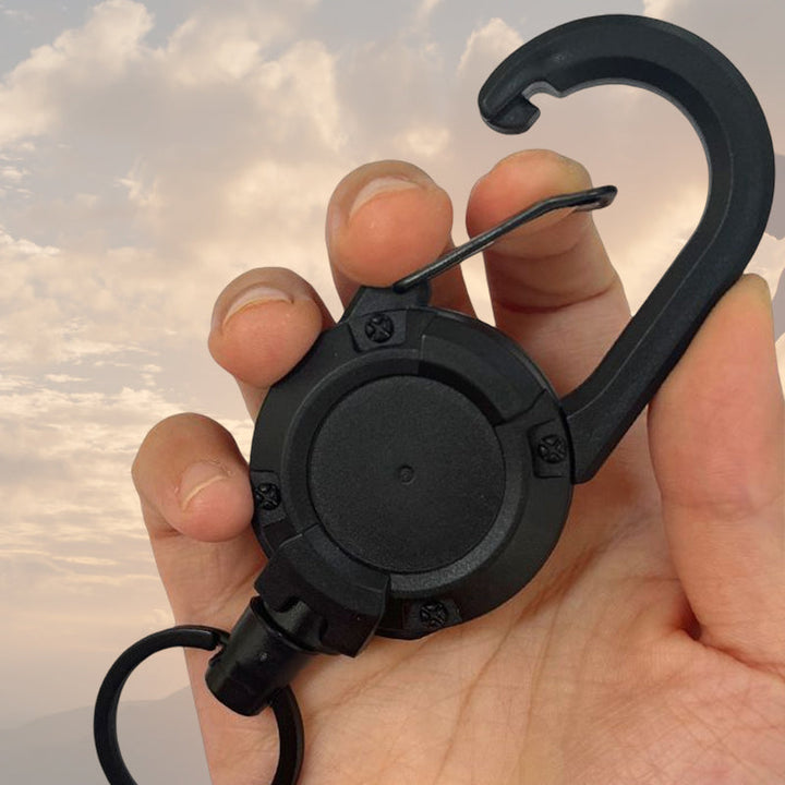 "Svart/vit multifunktionell nyckelring med infällbar vajer, hållbar aluminiumkarbin för utomhusbruk, ca 12,5 cm lång."