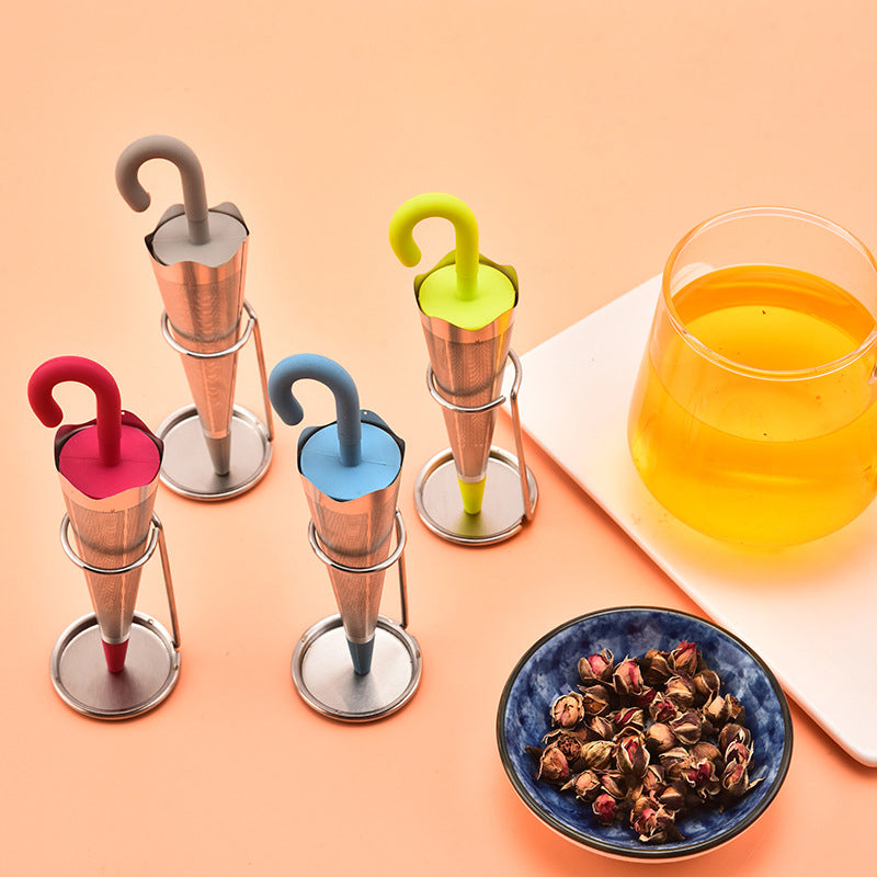 Teinfuser i paraplyform av rostfritt stål med lekfull design, i grönt, rött, grått eller blått, perfekt för tebryggning.